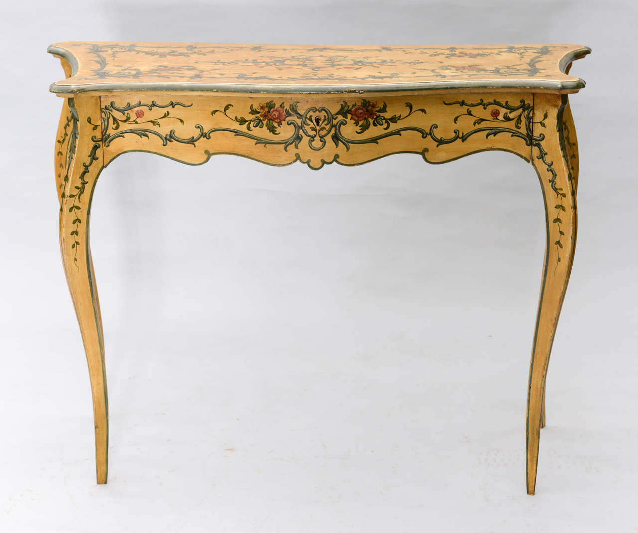 Console table, having serpentine top, single drawer in apron; handpainted with floral and scrolling motifs; raised on cabriole legs.

Stock ID: D5709