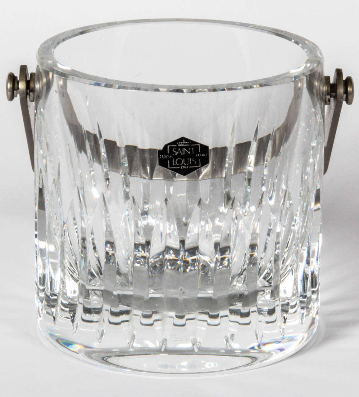 Cut lead crystal ice bucket with stainless steel handle by Saint Louis. France, circa 1970.

Dimensions: 4.75” W x 4.75” H
