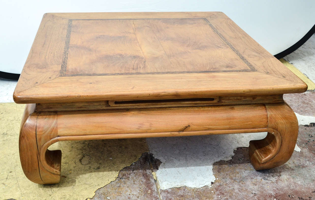 Chinese Square Pale Wood Coffee Table With Curved Turned In Legs. At The Center Top Of Each Side Of The Base Is A 12 Decorative Cut Out.The Top Overhangs The Base.A Diagonally Mitered & Pegged Joint Is At The 4.5