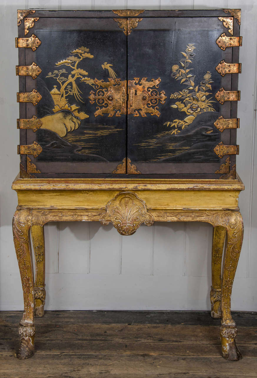 with fitted interior of drawers on a carved gilt wood and gesso stand with cabriole legs and good feet