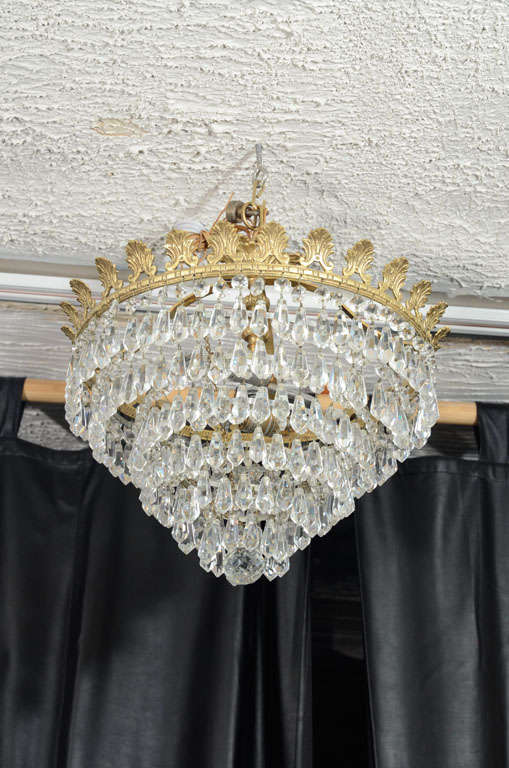 A beautiful flush mounted round ceiling light.with finely crafted  bronze leaves and crystal prism.