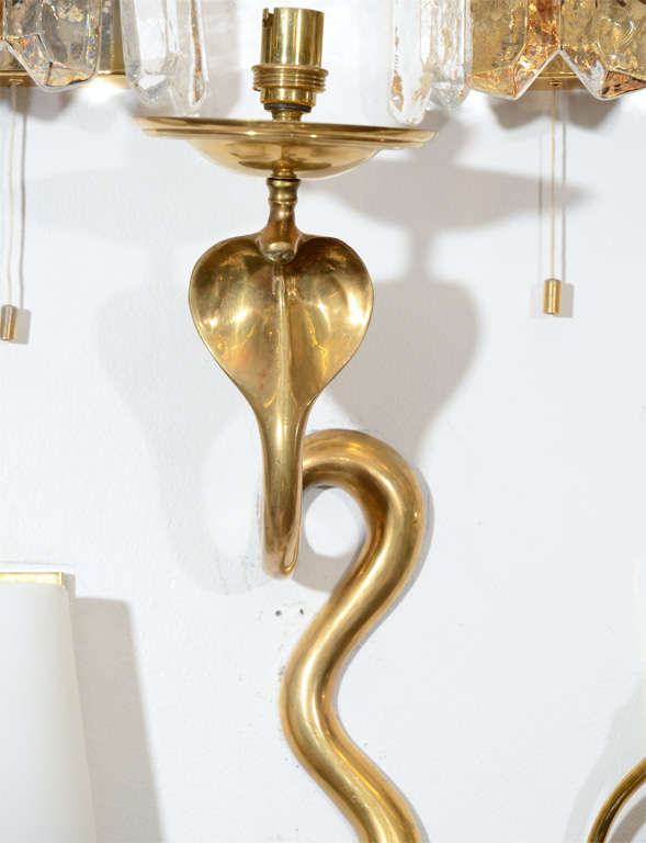 A single vintage French sconce. This solid brass piece is highly sculptural and beautifully shaped into a cobra.