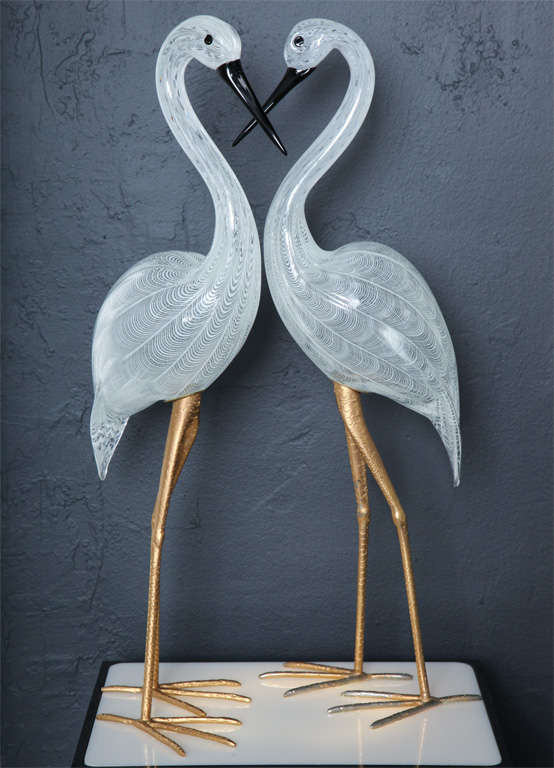 Clear and white handblown Murano glass cranes perch on long, gilt metal legs.