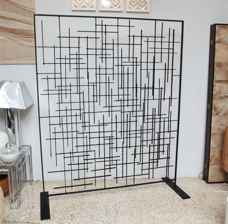 Salvaged from a mid-century modern ranch in Miami, this gorgeous wrought iron room divider was custom-made for the home. Originally attached to the ceiling, we've made it self-standing for easy maneuverability.
