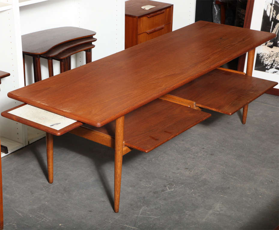 Danish Modern Teak coffee table with leaf extension and 2 pull out trays.  Features oak legs.
