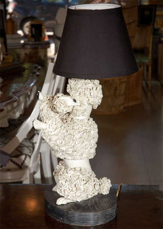 White poodle lamp with spaghetti style porcelain, hand painted black features.  Sits on black stained wooden base.  Black lamp shade.