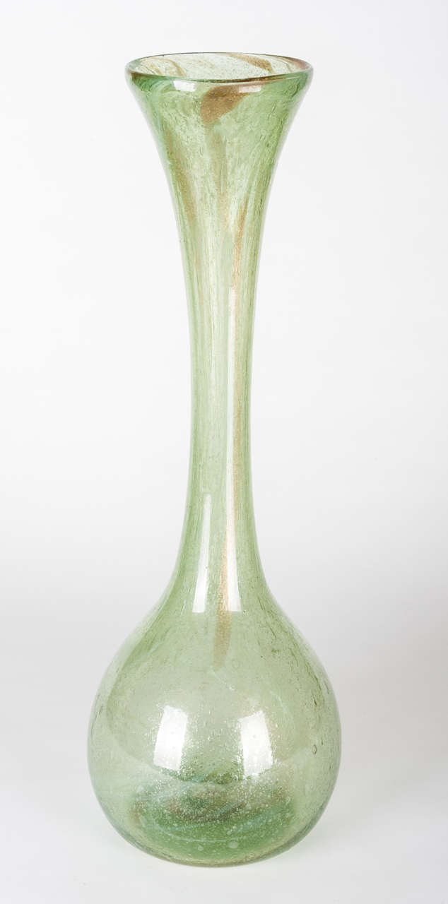 This vase is part of the Clutha Glass range designed in the 1890's by Dr Christopher Dresser for James Coupar and Sons of Scotland and probably retailed by Liberty & Co. At 55cm high, this is an unusually large example and a real statement piece.