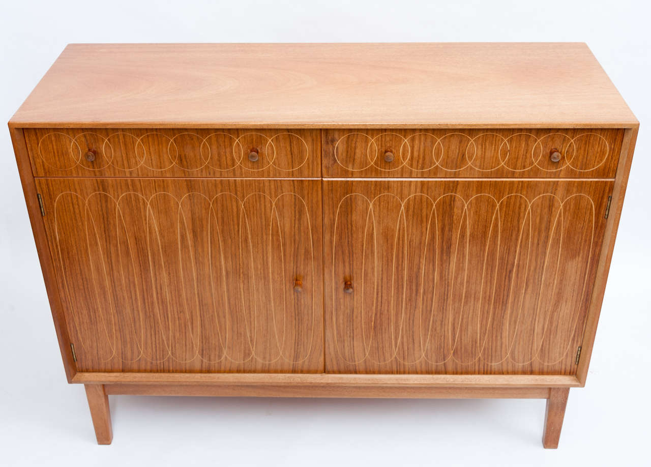 This is the rarer cousin of the more frequently found Helix sideboard designed by David Booth and Judith Ledeboer, made by Gordon Russell in Broadway, England and exhibited at the Festival of Britain in 1951. After the second world war, there was a