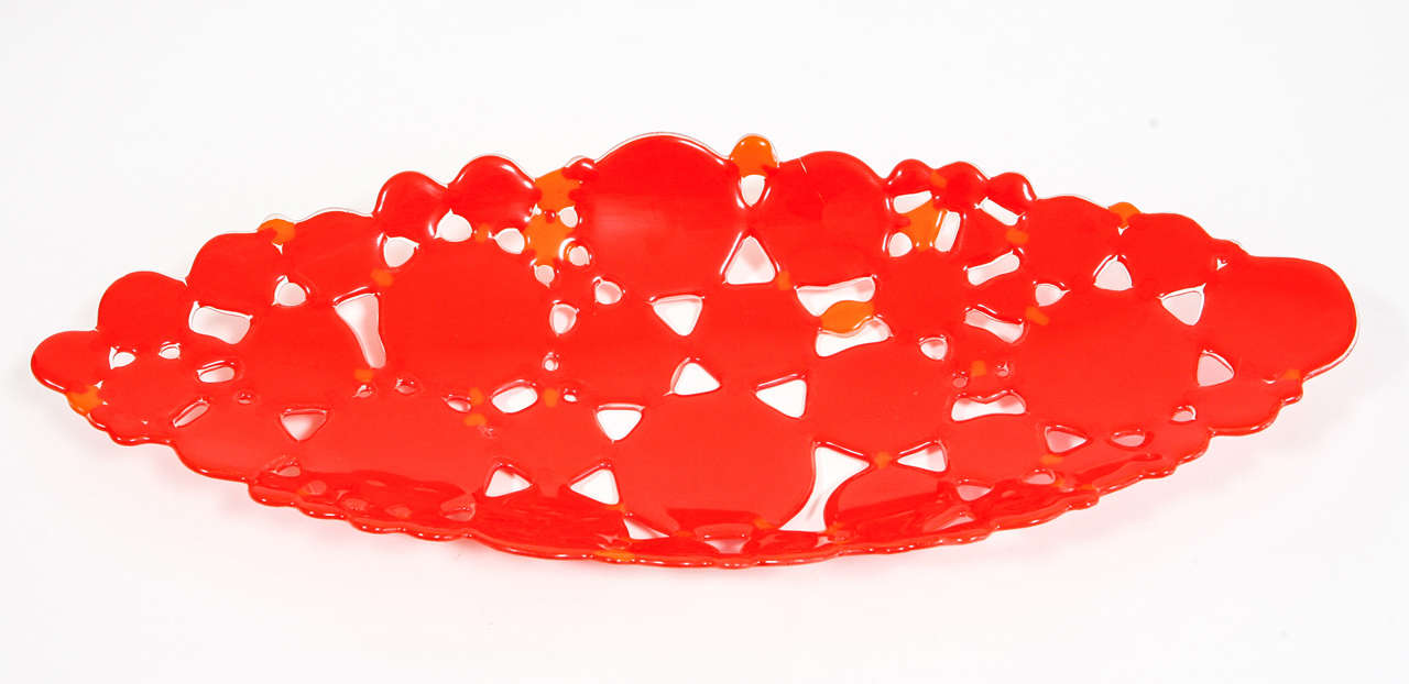 This custom low bowl is made by Beatrice Tesdorf. The overall orange-red color is a major splash of color. Ms. Tesdorf has been a source for Tiffany's and Barneys NY .