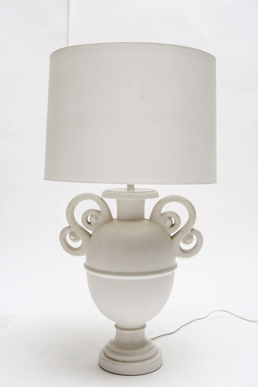 A beautiful pair of white cast resin lamps with scrolled handles and new white linen shades with diffusers. The lamps are inspired by a design by sculptor Alberto Giacometti. Based on the quality, we believe they may have been manufactured by Sirmos.
