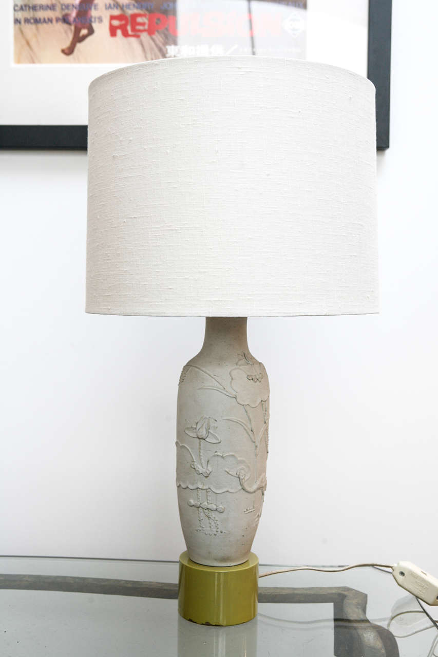 Charming little table lamp, designed by William Haines for the Prinzmetal estate in Beverly Hills, c. 1950.

The body of the lamp is hand crafted bisque covered with a relief of flowers, plants, an birds.

The body sits on a painted wood