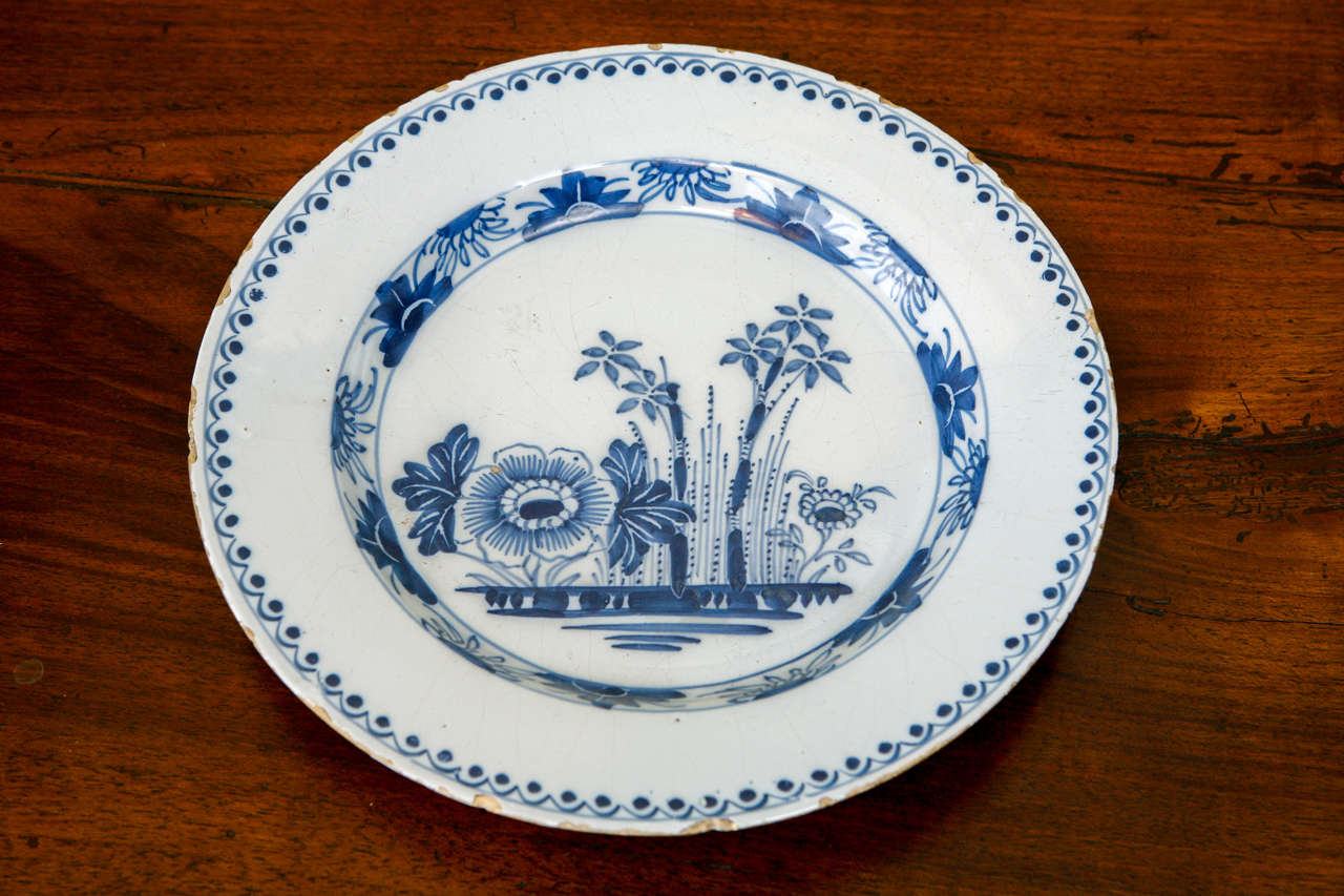 A Dutch Delft Plate with Flowers, 18th c.