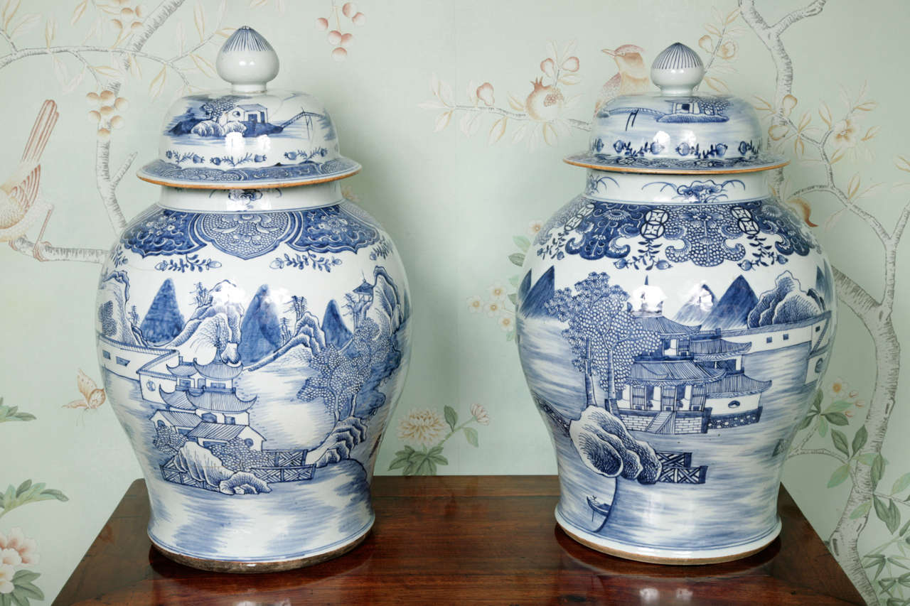 A matched pair of very large pair of Chinese blue and white porcelain vases dating from the last quarter of the 18th century.  Elaborately decorated in Oriental landscapes showing pagodas, gardens and bridges. Both vases have sustained heavy damage