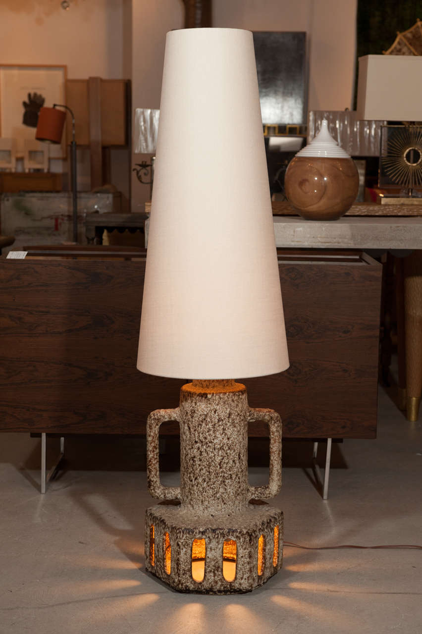 Glazed ceramic lamp with updated rugged vanilla linen rimless lampshade.
Multi-point illumination .. from within shade and lower perforated section of lamp.