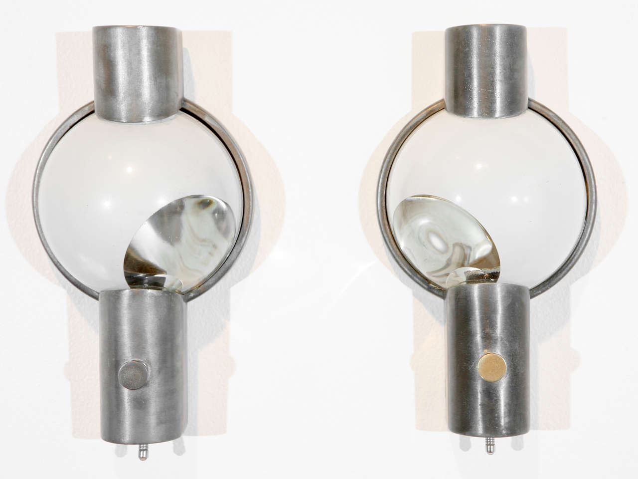 Pair of sconces designed by Henry Dreyfuss; originally used in trains. One sconce has a brass finial and one has a chrome finial.