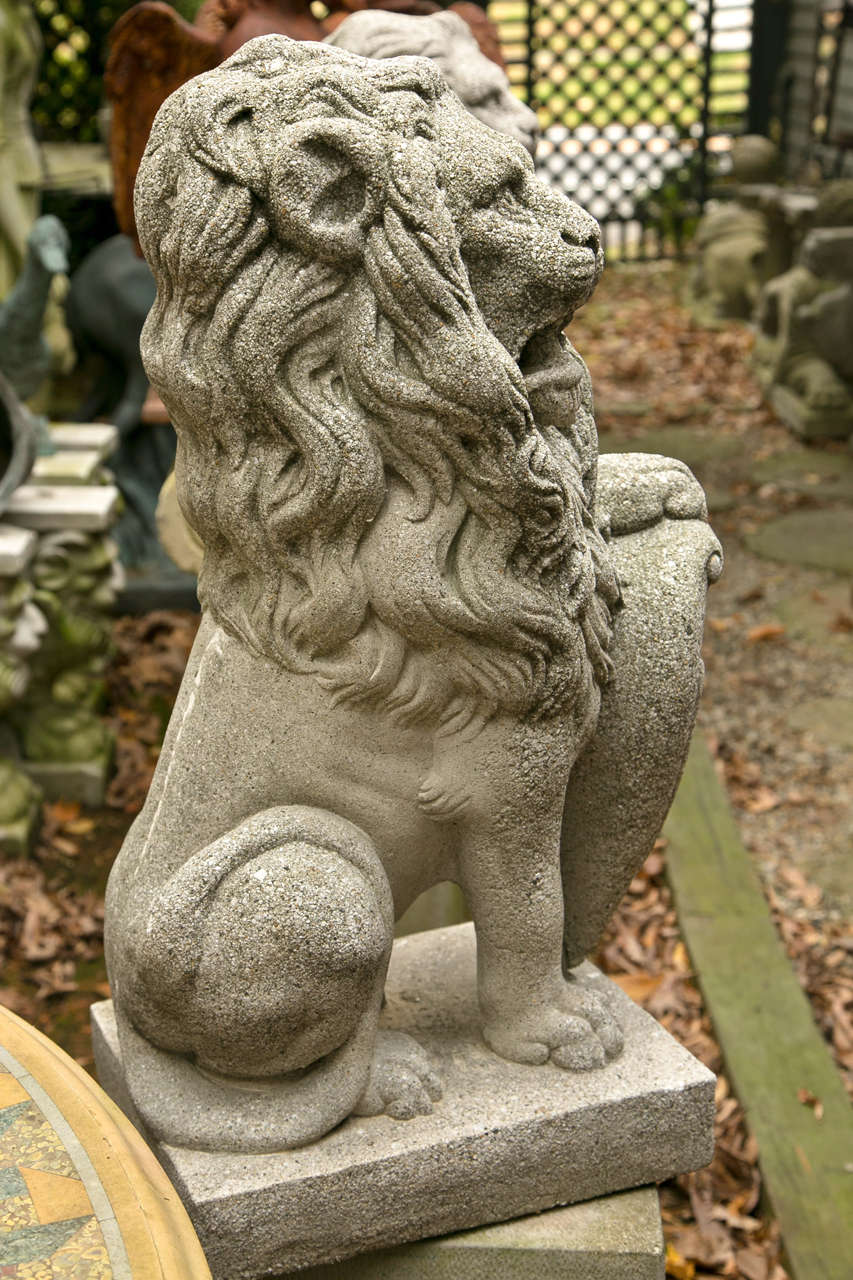 Pair  Seated  Cast Concrete Lions with Shields In Good Condition For Sale In Woodbury, CT