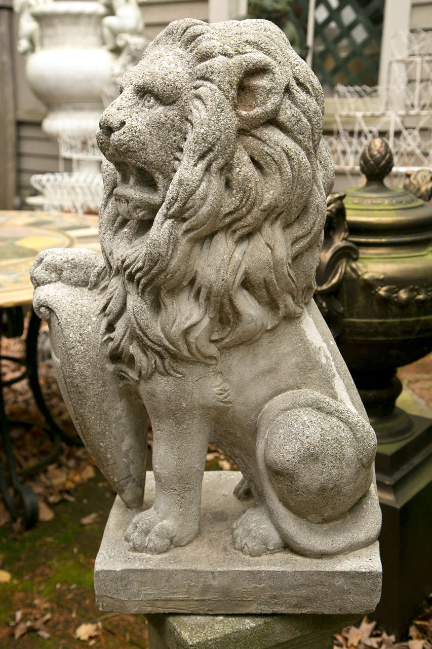 Pair Seated Cast Concrete Lions with Shields For Sale at 1stDibs