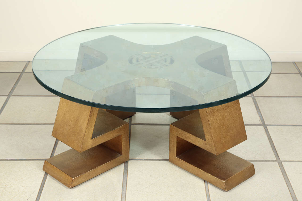 Beautiful oriental influenced coffee table with a centre medallion by James Mont.
The table is finished in an antiqued gold leaf finish, minor leaf loss to finish