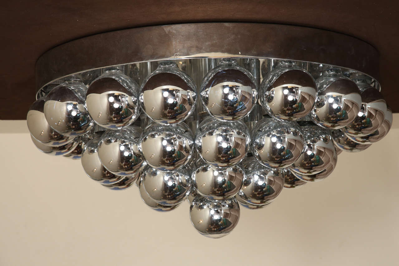 Spectacular flush mount chandelier with 37 huge chromed light bulbs.
May also be installed as a sculptural sconce.