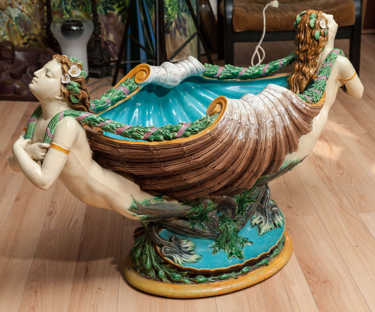 Monumental Minton Majolica fountain modeled as two mermaids supporting a shell form bowl with foliate garlands and see weed motives at the base.