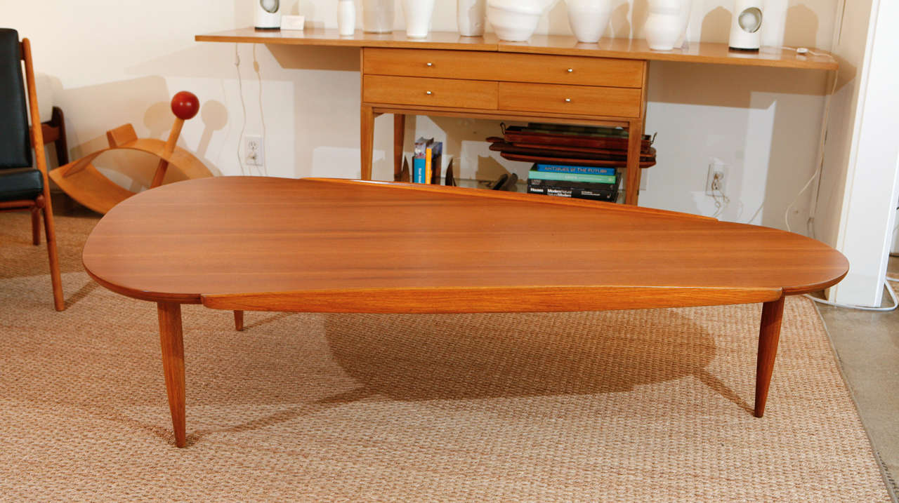 This substantial boomerang coffee table is an extremely rare design by Lane. A large scaled walnut top rests on three sculpted legs.