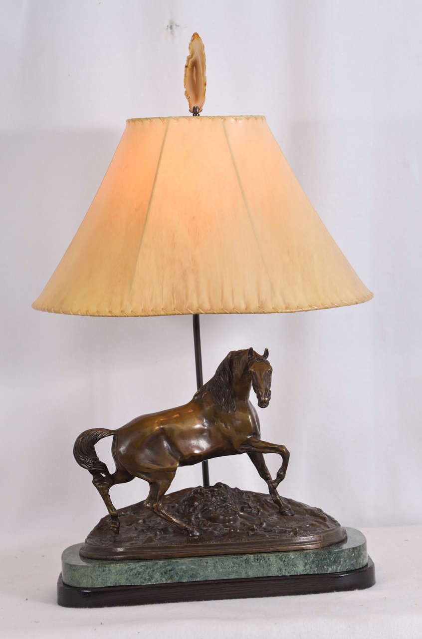 Custom-made table lamp with the "Bronze Stallion" by French artist of the mid-1800s, Pierre Jules Mene, mounted on a green marble base with a black wooden base for a figurine mount, and oval sheepskin leather lamp shade. The bronze is a