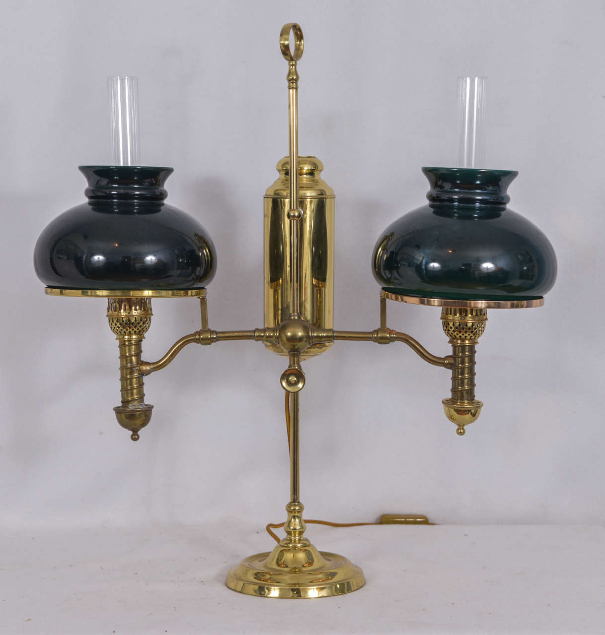 Double student lamp, originally oil, electrified. 1900s oil lamp with original green, cased glass lamp shades, new chimneys.