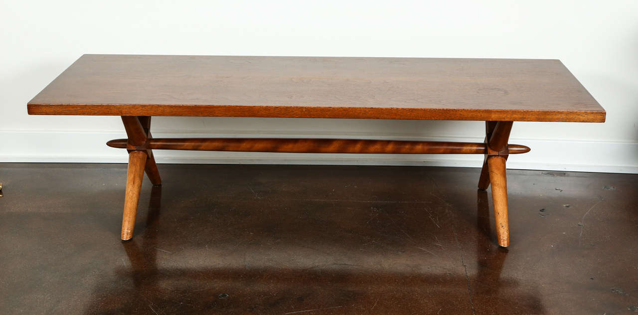 Handsome walnut X-base low table by T.H. Robsjohn-Gibbings in the early 1950s.

The table has a beautiful patina, with the Classic spear center bar underneath.

Original condition.