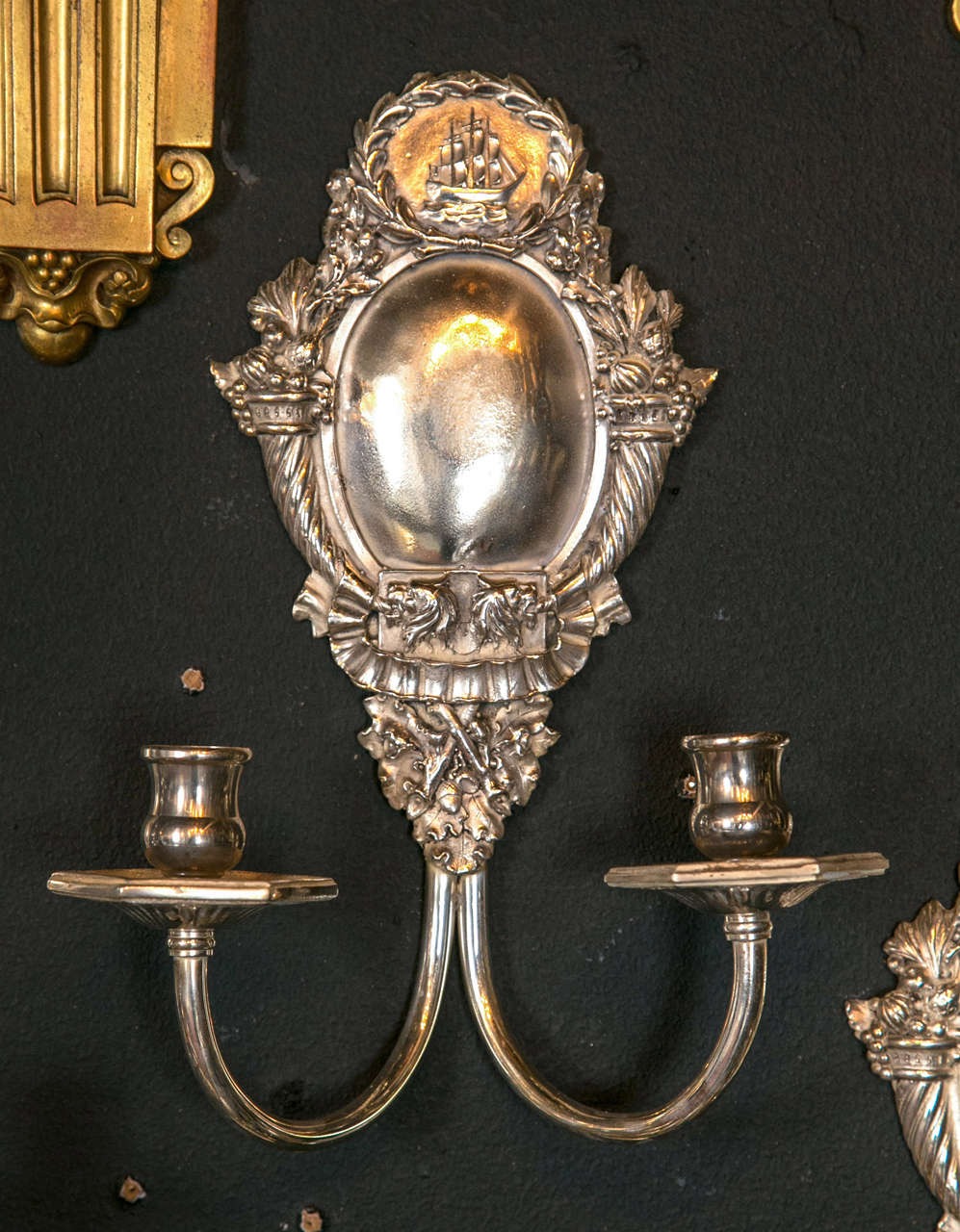 Pair of Caldwell silver plated sconces, featuring a ship design, circa 1920s. twelve available, priced per pair. Will be newly wired upon purchase.