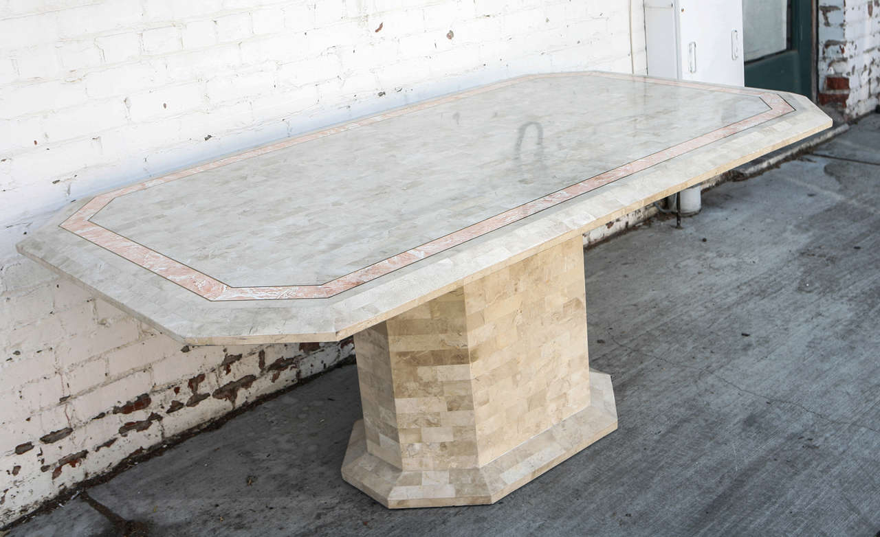Travertine dining table with pink stone inlay