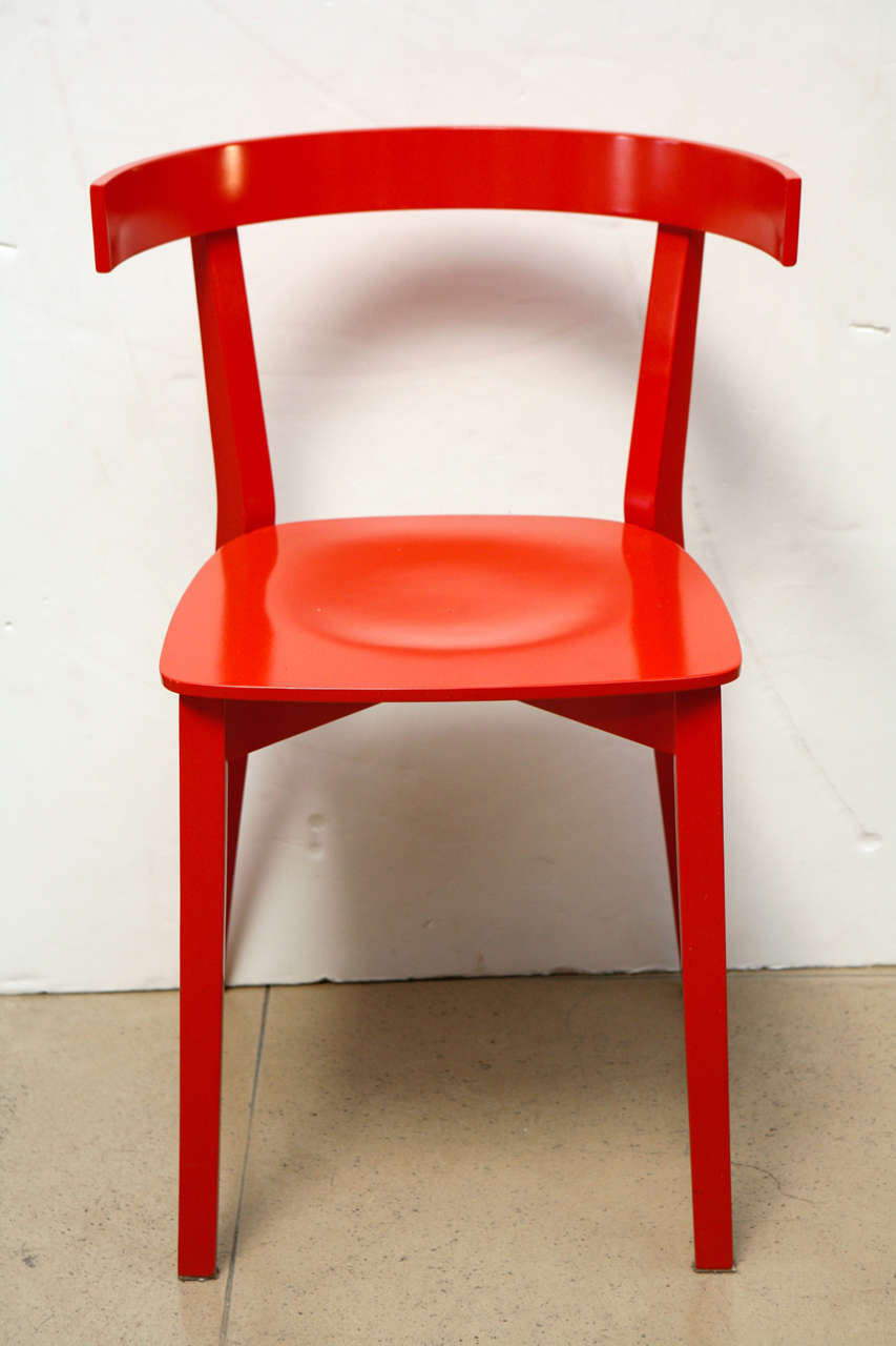 Four red dining chairs in the Style of Wagner