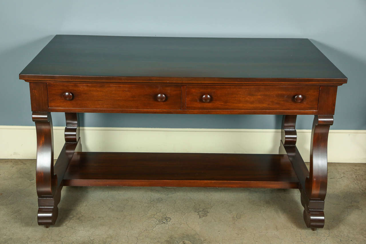 American mahogany library table in the Empire style, circa 1915-1930. Newly refinished.