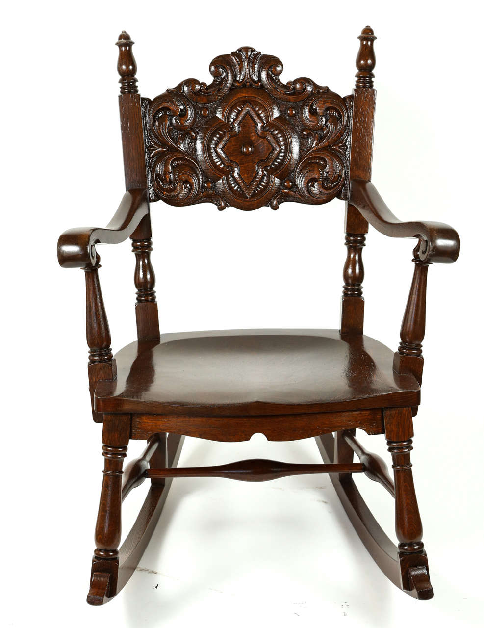 Oak rocking chair with carved wood seat back that has been newly refinished, circa 1930s.
