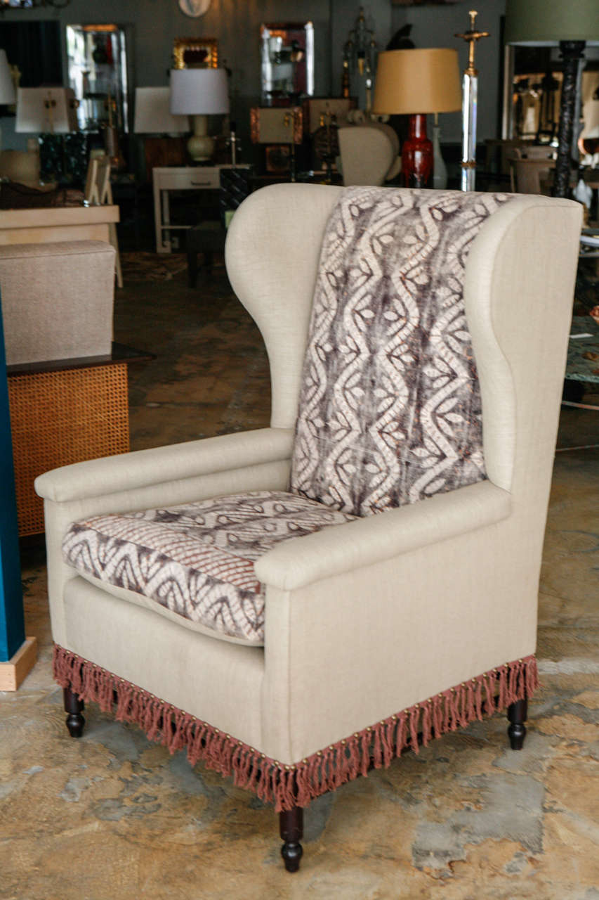 Bloomsbury inspired, reinterpreted and fully restored pair of wing chairs with new upholstery (cotton blend with a linen look and feel). Inset fabric is of vintage bedspread from India. Custom hand-dyed fringe. Wood refinished in dark walnut. Custom