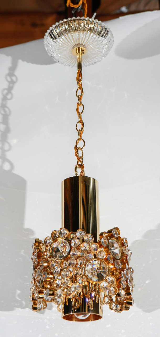 Mid-20th century pair of Palwa pendants. Brass, crystal, crystal canopy. Total drop height is 22.25 inches. Great condition with new electrical. Pair price.