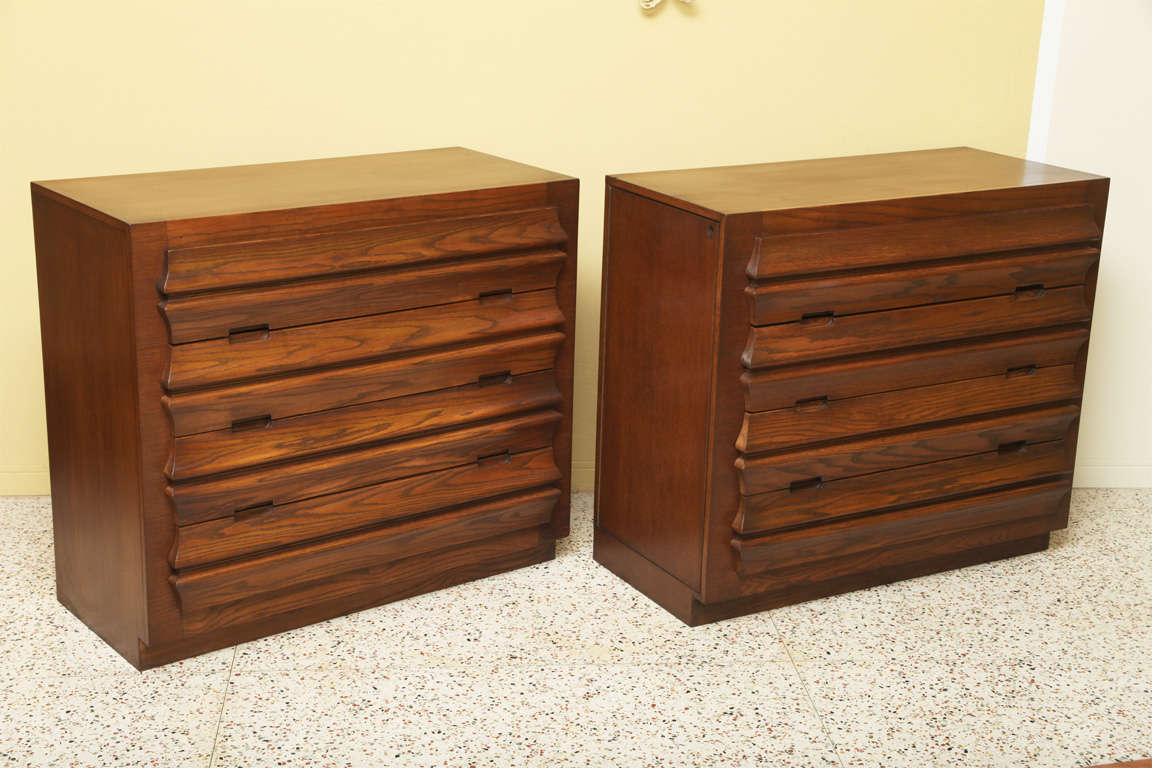 Beautiful uniquely sculpted drawer fronts highlight this pair of exceptional oak Romweber dressers, their design attributed to Harold M. Schwartz.  Beautifully figured oak with a rich warm patina highlights these exceptionally solid and well
