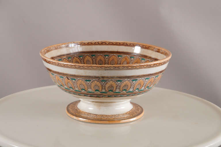 Ironstone footed Punch bowl with beautiful bold exterior decoration in painted transfer Anthemian Motif. Interior features Herecles slaying the Nemean lion.

 According to one version of the myth, the Nemean lion took women as hostages to its lair