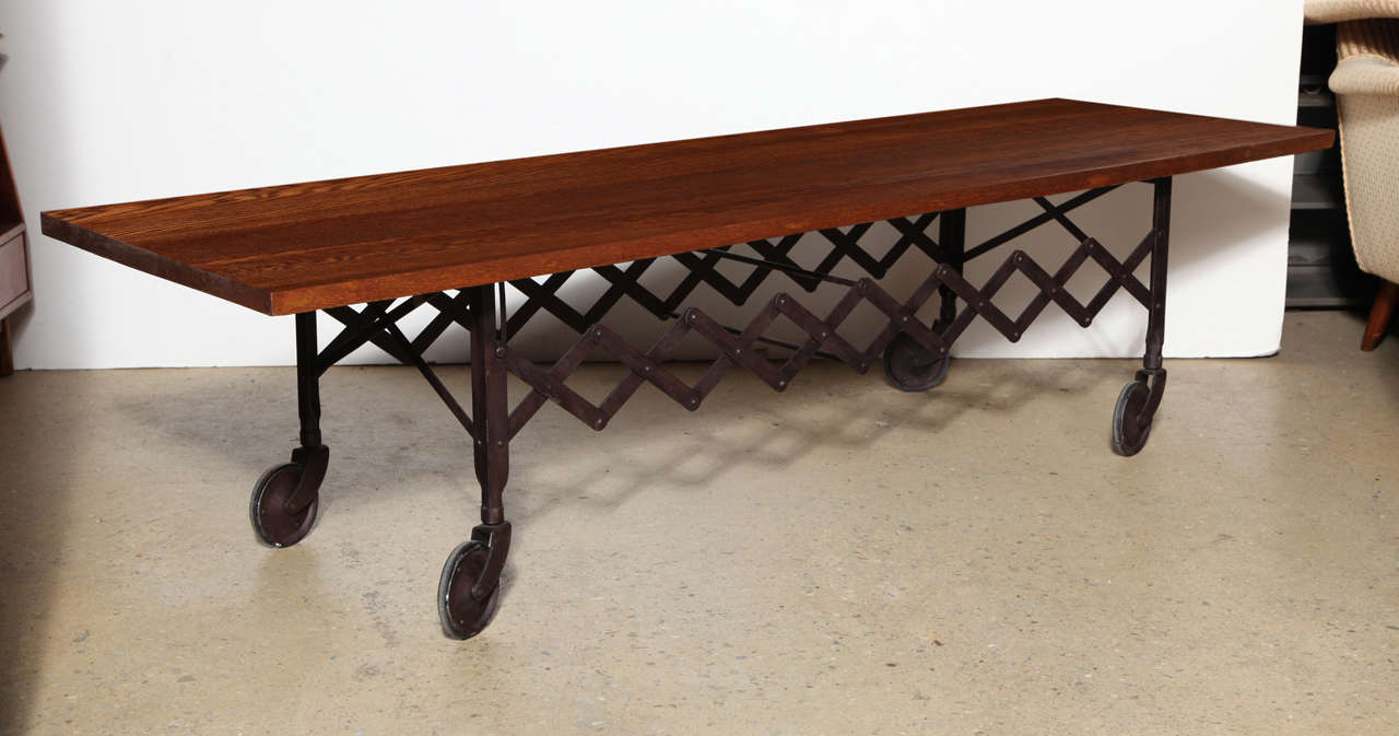 Extra long, early 20th century, Steel Scissor Trolley Coffee Table with 6+ foot solid Dark Oak top. Featuring a rectangular, elongated and fixed accordion scissor dark patina steel base and vintage 75 long x 1.18 thick solid Oak surface. Original