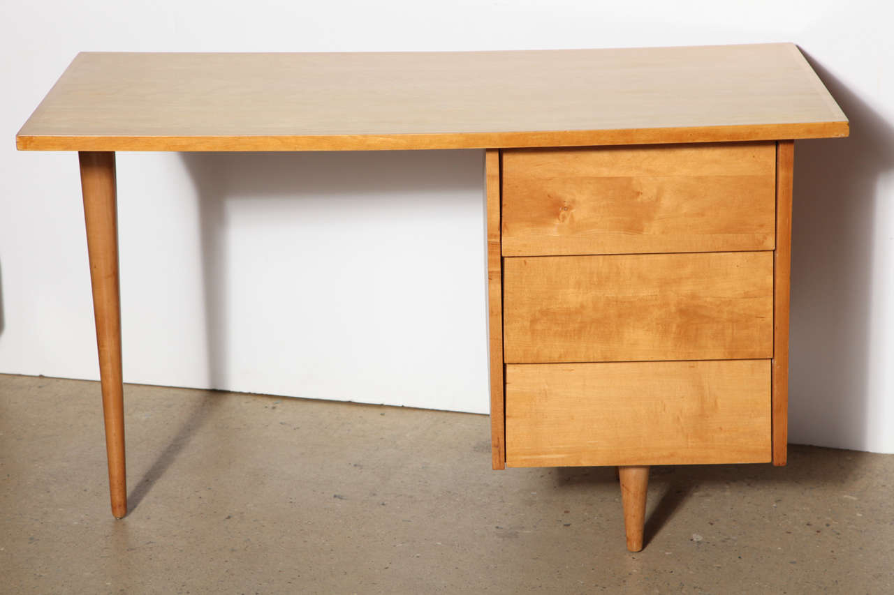 early Florence Knoll solid Maple Desk in natural finish with 3 drawers and 3 legs.  Refinished