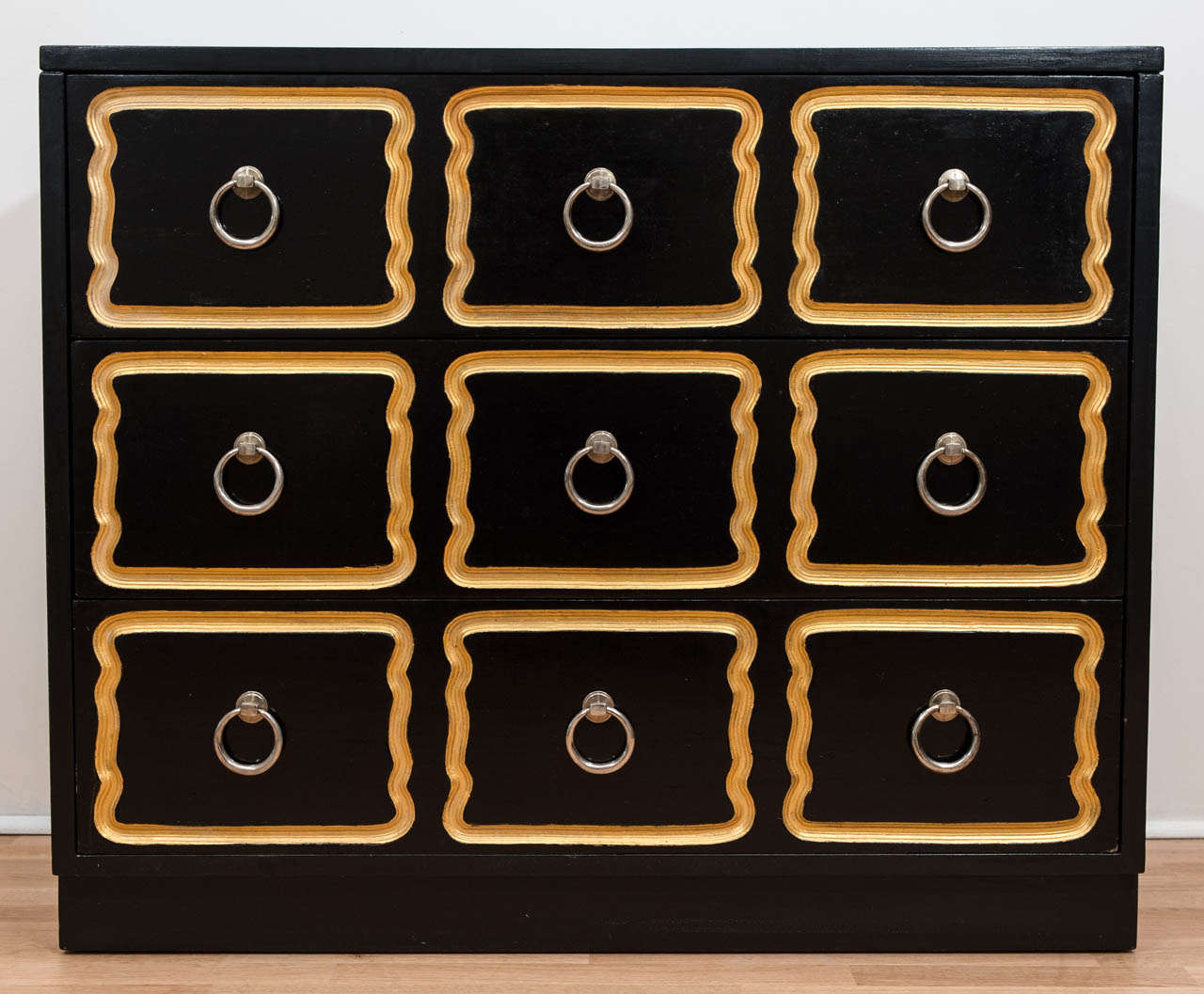 An iconic and glamorous chest of drawers that is as hip
and current today as it was when it was
first produced. Classic black with gold trim.