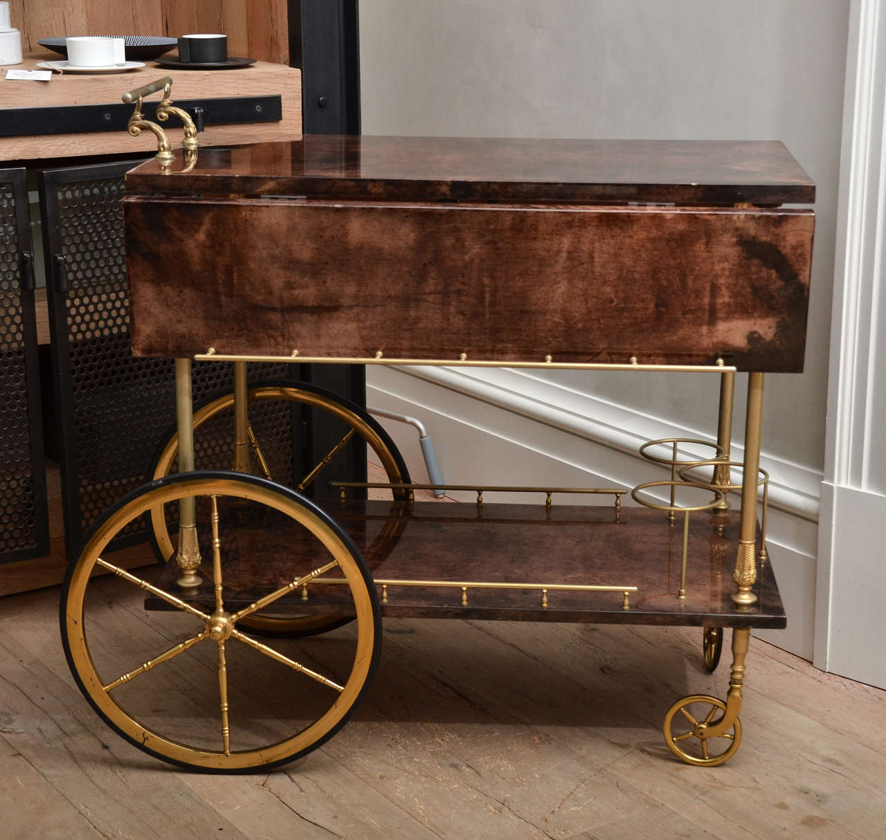 Stunning Mid-Century Aldo Tura bar cart in lacquered goatskin and brass detailing and wheels. Two additional leafs on either side can open.