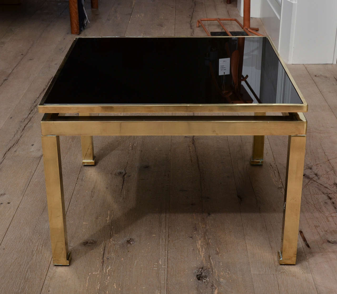 Stunning pair of midcentury guy Lefevre for Maison Jansen side tables in brass and smoked dark glass.