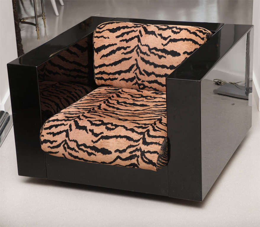 Pair of black lacquer cube chairs with animal print fabric.