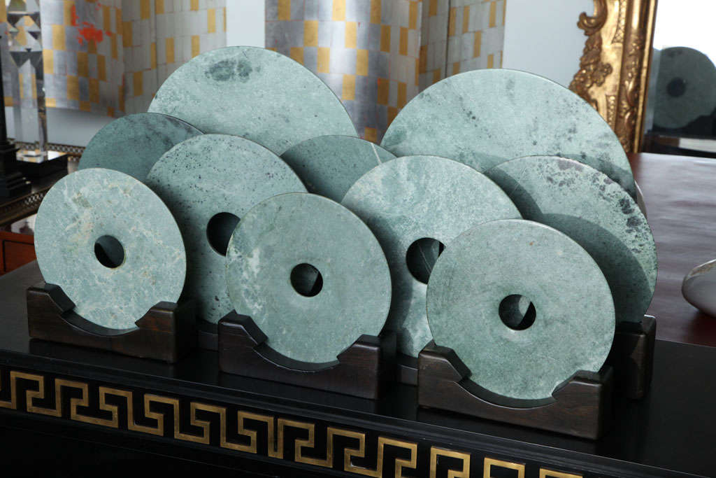 Jade discs on later wooden stands, of varying sizes, can be sold individually or in groups.