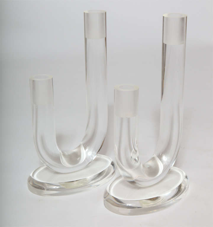 A chic pair of lucite candleholders on lucite stands.