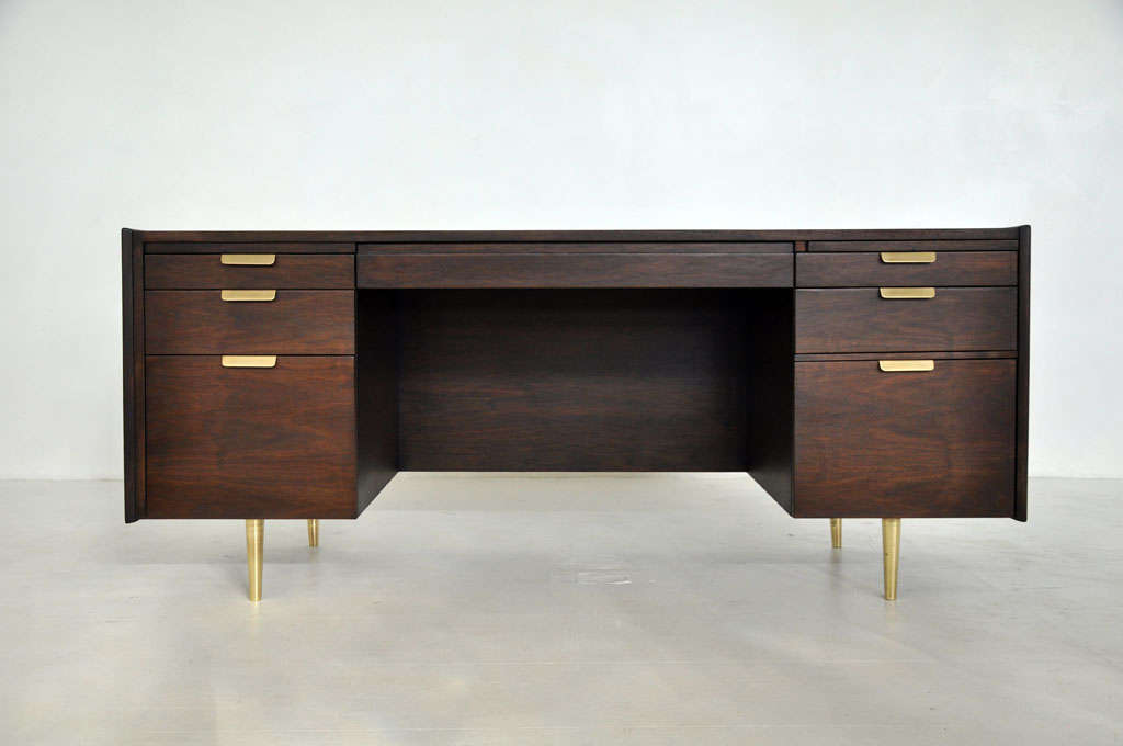 Executive desk by Edward Wormley for Dunbar.  Walnut case with brass hardware and legs.