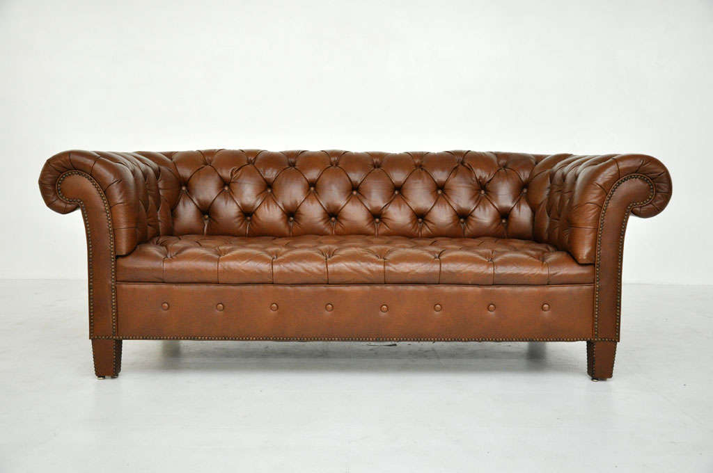 Brown leather chesterfield sofa by Baker.