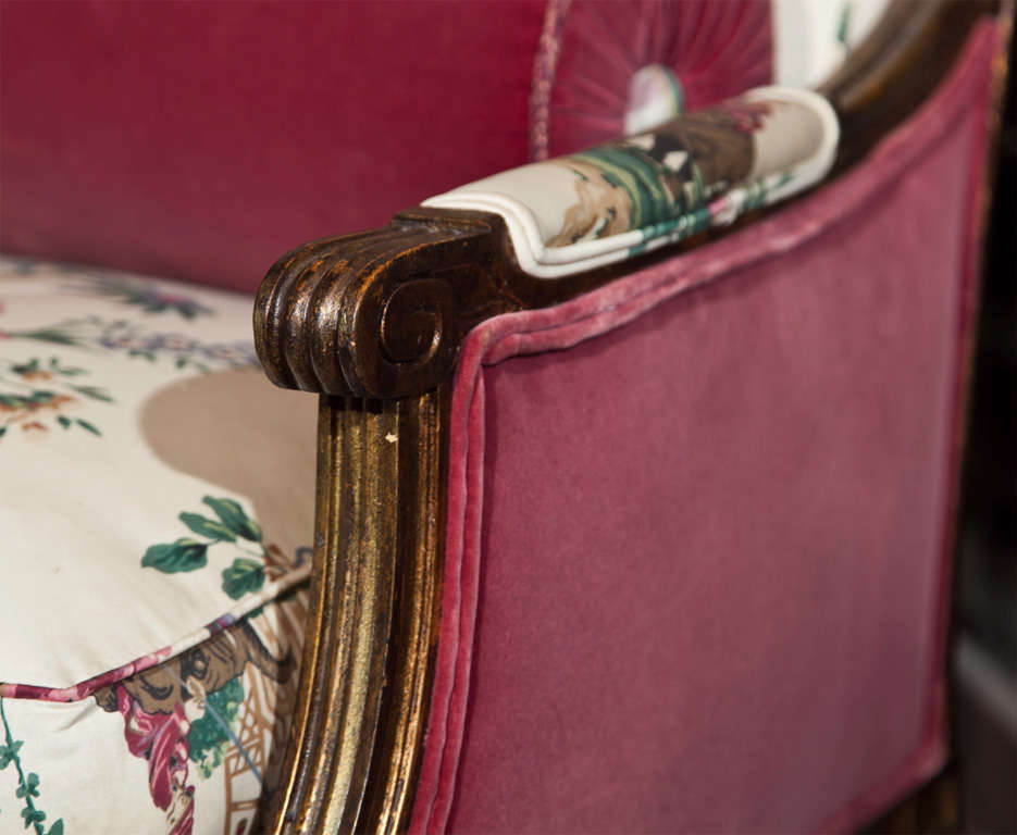 Pair of French Louis XVI style marquises, circa 1940s, beautiful painted and gilded frame upholstered in Chinoiserie scene fabric with velvet bolster pillows, cushioned seat, raised on tapering circular legs. By Maison Jansen.