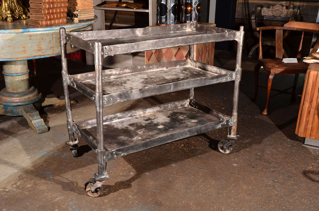 Artfully hand crafted, all steel industrial cart.  Completely hand riveted with gothic corner supports and original wheels.