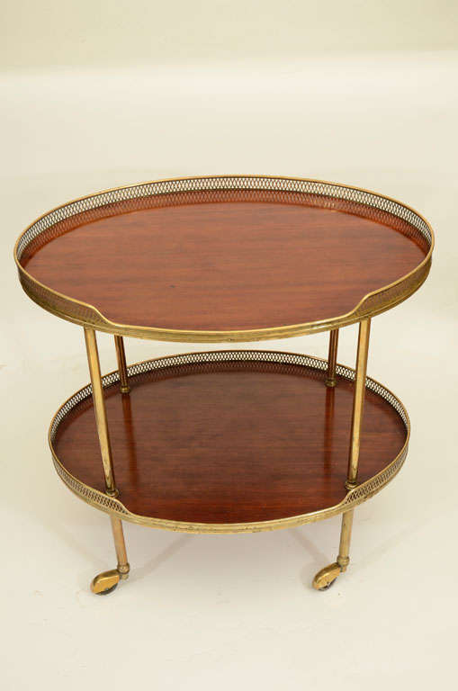 Oval Brass and Mahogany Two-Tier Galleried Drinks Trolley/End Table Raised on Brass Casters.  England, Mid 20th Century<br />
<br />
27 inches wide x 19 inches deep x 27 inches high